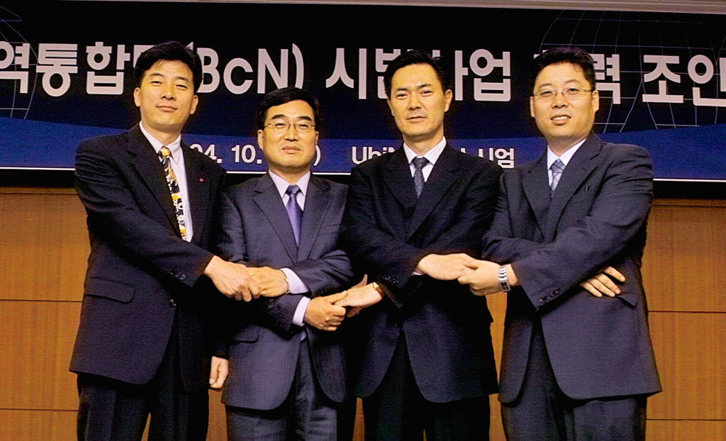 The representatives of `Ubinet` consortium members are shown signing the MOU. This includes Sung Won Seo (6th position from right side in front line), head of SK Telecom`s New Business Division.